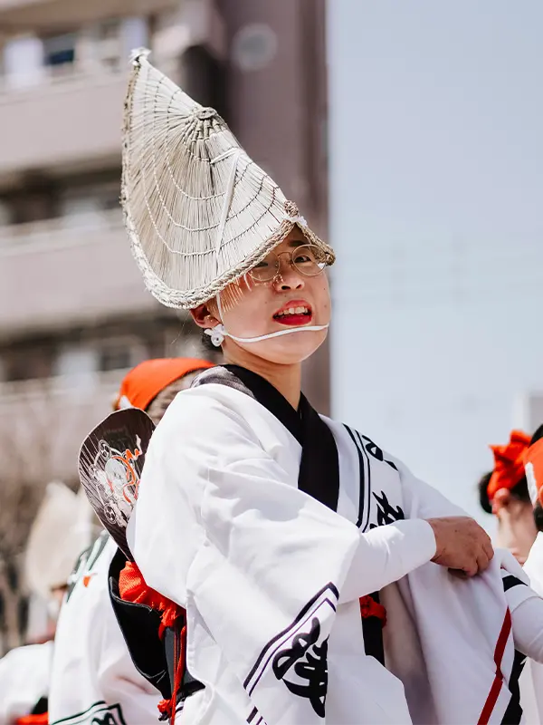Performer in traditional Japanese attire during a cultural festival.