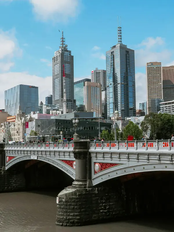 Melbourne skyline with Yarra River bridge and modern skyscrapers, popular city for international students in Australia.