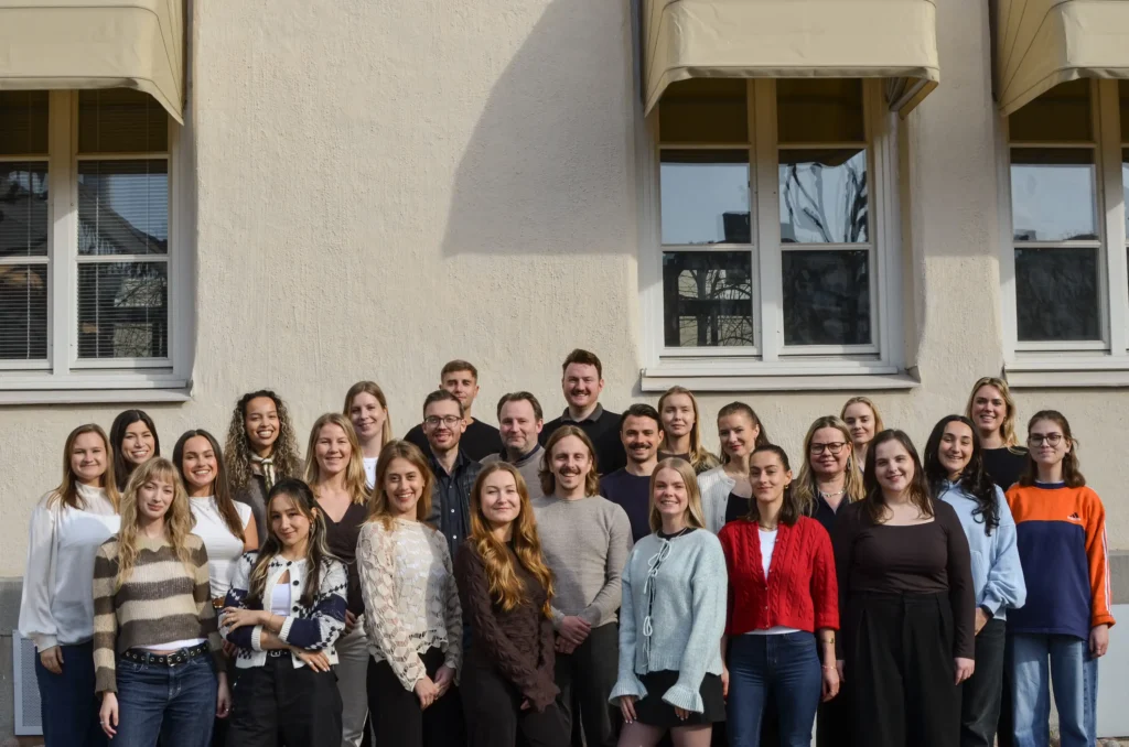 Group photo of Beyond Abroad team members standing together outside office building