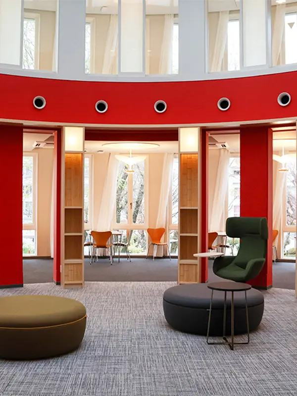 Modern study areas at Temple University Japan with red interior design.