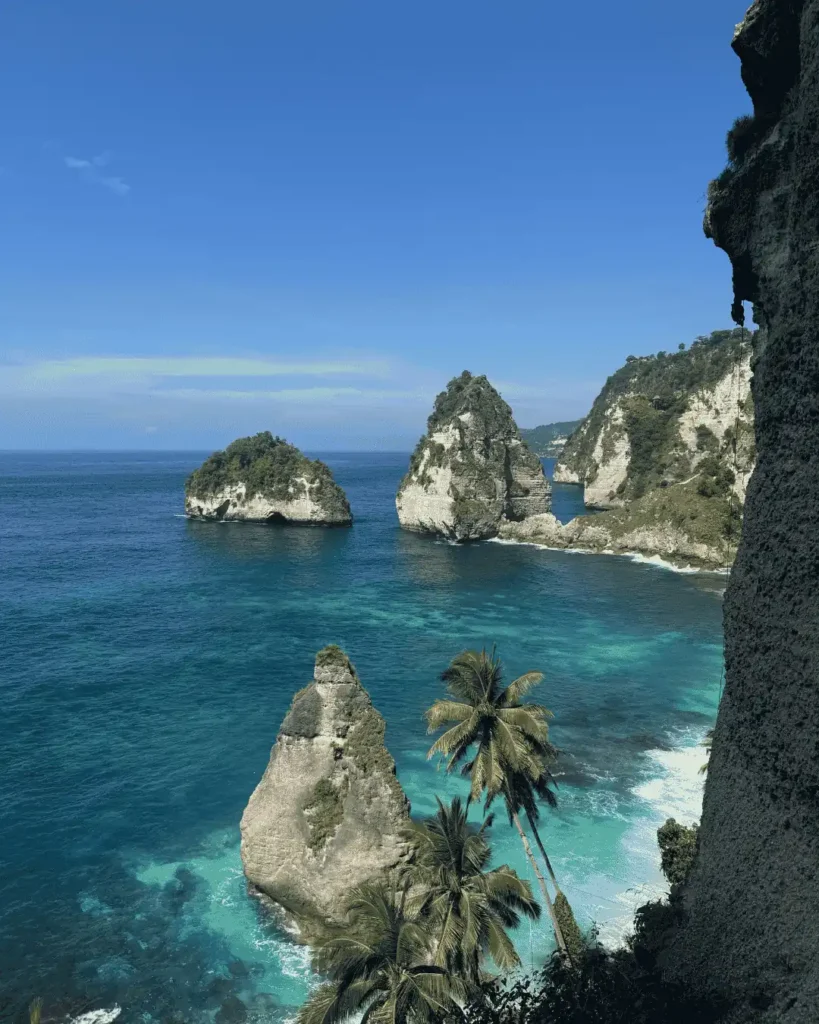 Aerial view of the ocean surrounded by mountains in bali