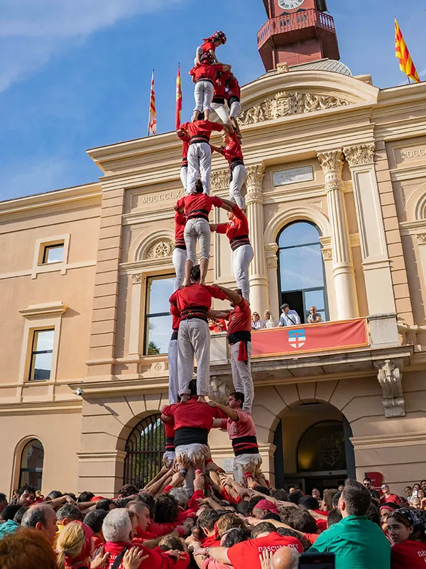 Castellers building a human tower during a traditional festival in Catalonia, Spain