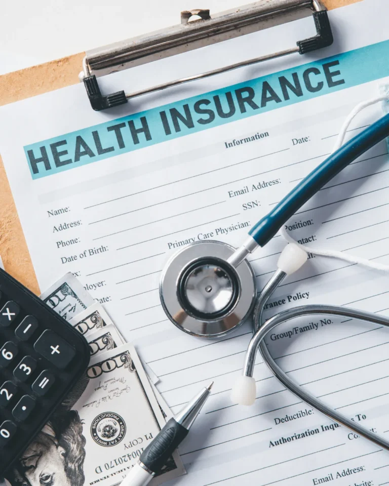 Health insurance contract surounded by medical accessories