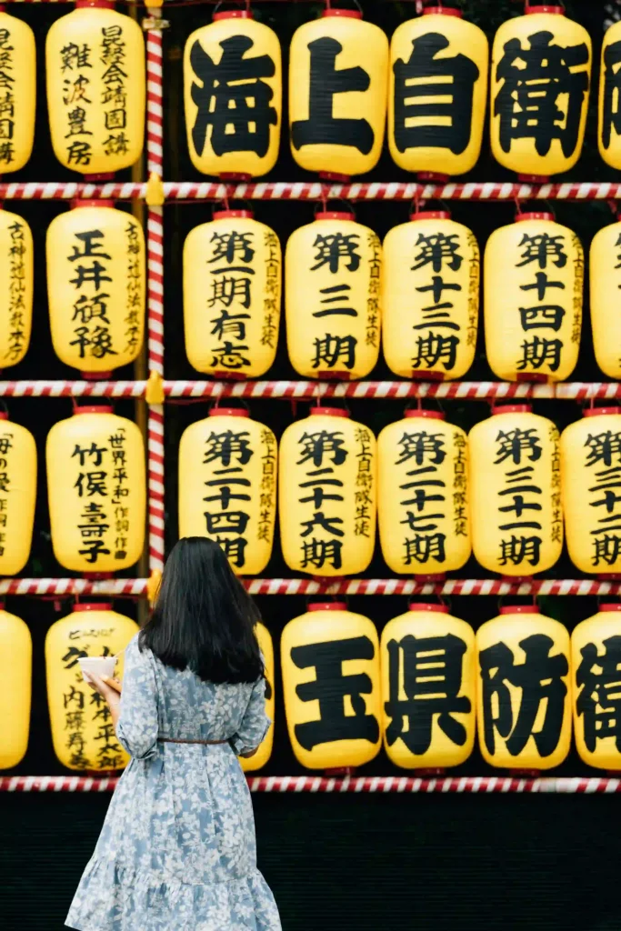 Girl standing in front of Japanese lanterns