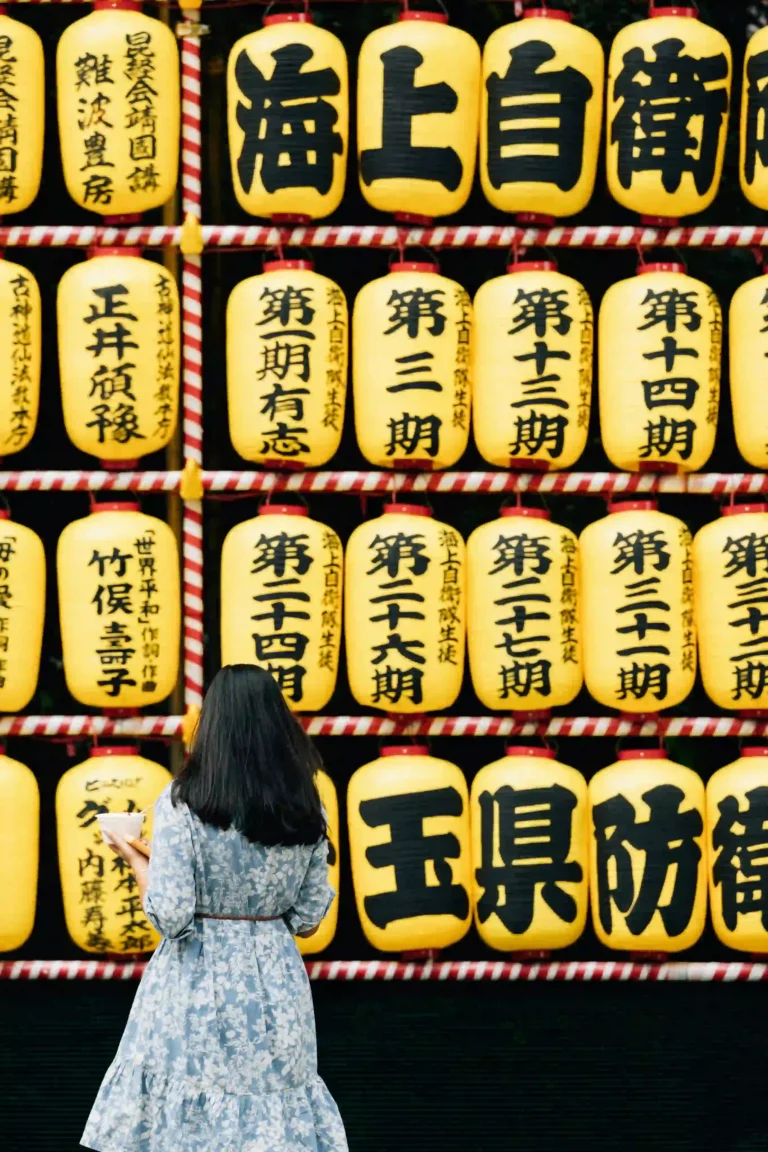 Girl standing in front of Japanese lanterns